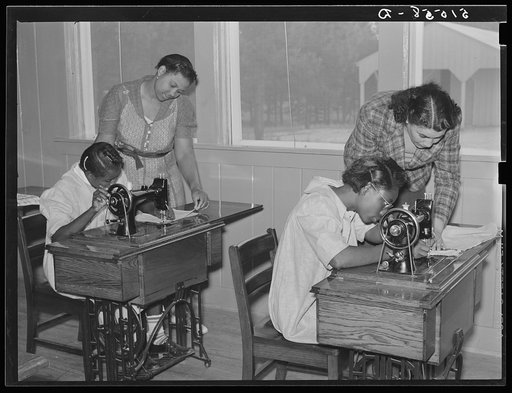 Thelma Shamburg and Mrs. Spragg (or Sprague), NYA (National Youth Administration) state supervisor, helping Catherine Plumer and Sallie Titus at sewing machines in school economics room. Gee's Bend, Alabama