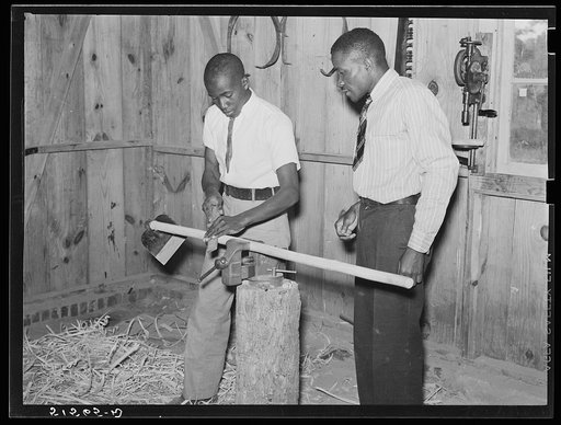 School principal Robert Pierce helping boy make a hoe in shop class. Gee's Bend, Alabama