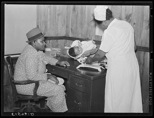 Nurse Shamburg weighing Ira Dencie Pettway's baby in project clinic. Gee's Bend, Alabama