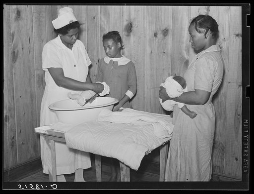 Nurse Shamburg demonstrates care of baby bottles to Mrs. Paralee Coleman and Marie. Mothers have to work in field and children are left at home to care for babies. Health clinic, Gee's Bend, Alabama