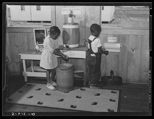 Rosa Law and Sanders Whitfield washing hands before lunch in primer and first grades clean up corner. Flint River Farms, Georgia