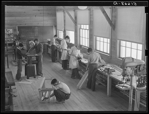 Part of shop class in school with Robert Gentry, teacher, in center at machine. Ashwood Plantations, South Carolina