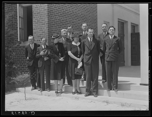Group of speakers and guests with project manager Mr. Cathcart (at extreme left) on steps of auditorium after May Day-Health Day program at Ashwood Plantations, South Carolina
