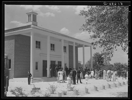 Project families, guests and schoolchildren leaving auditorium for picnic after May Day-Health Day program at Ashwood Plantations, South Carolina
