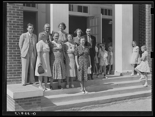 Group on steps of community auditorium with county doctor, project manager and nurse on May Day-Health Day program. Irwinville Farms, Georgia