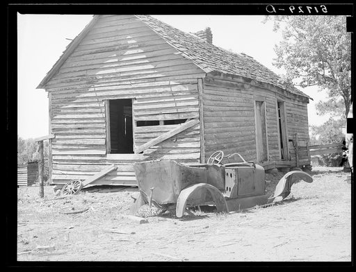 Deserted tenant farmer's shack and old car. Greene County, Georgia