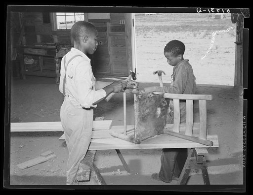 John Young and J.W. West repairing a chair in school shop class. Flint River Farms, Georgia