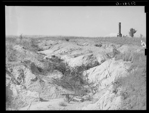 Soil erosion and remaining chimney of house. Greene County, Georgia