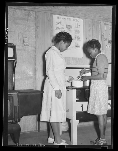 Student with teacher in home economics cooking classroom. Prairie Farms, Alabama