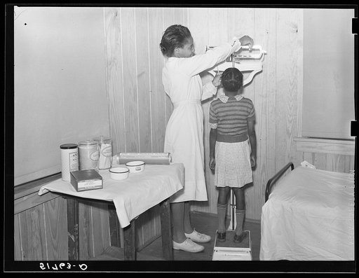 Child being weighed and examined in health room. Prairie Farms, Alabama