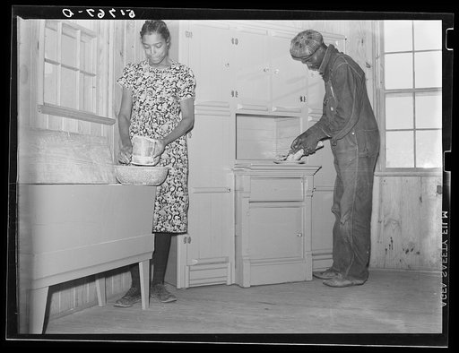 Project family in kitchen of their new home, showing cabinet and flour bin they built. Prairie Farms, Alabama