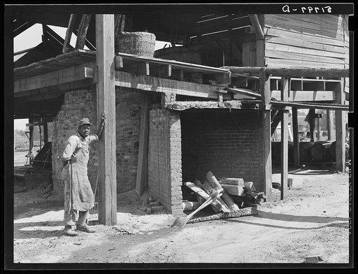 Negro worker who had been cleaning hearth in turpentine kiln, Iron City, Alabama