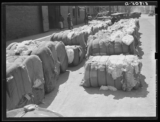 Burst bales of cotton on street near warehouse in Montgomery, Alabama