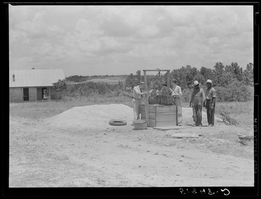 FSA (Farm Security Administration) supervisors inspecting new well on client's property. Greene County, Georgia