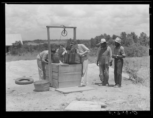 Untitled photo, possibly related to: FSA (Farm Security Administration) supervisors inspecting new well on client's property. Greene County, Georgia