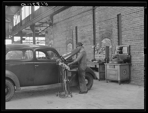 Testing motors of car in FSA (Farm Security Administration) warehouse depot. Atlanta, Georgia