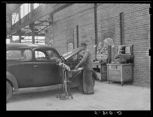 Testing motor of car in FSA (Farm Security Administration) warehouse depot. Atlanta, Georgia