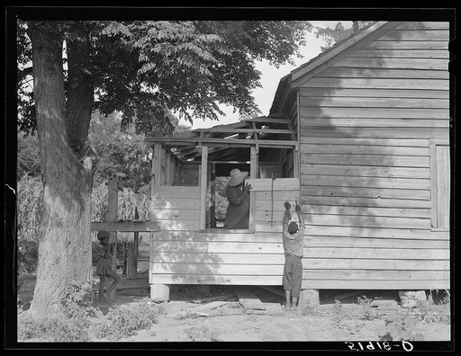 Pauline Clyburn, rehabilitation client, Manning, Clarendon County, South Carolina, and her son repairing home