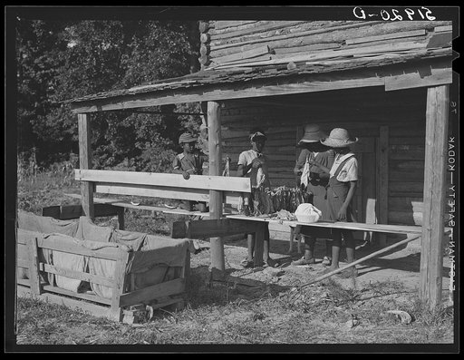 Pauline Clyburn, rehabilitation client, and her children stringing tobacco. Manning, Clarendon County, South Carolina