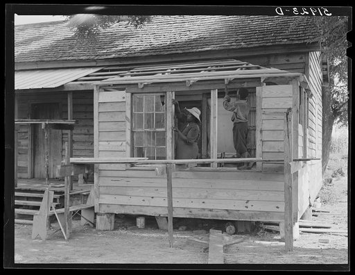 Untitled photo, possibly related to: Pauline Clyburn, rehabilitation client, Manning, Clarendon County, South Carolina, and her son repairing home
