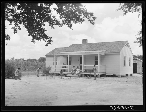 Children of Frederick Oliver, tenant purchase client, sweeping yard in front of new home. Summerton, South Carolina
