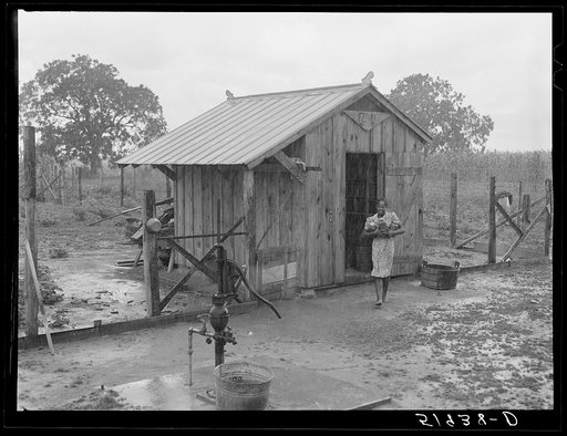 Daughter of Frederick Oliver, tenant purchase client, bringing canned goods in from smokehouse. Summerton, South Carolina