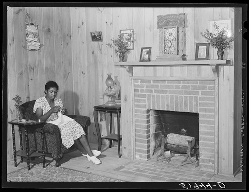 Daughter of Frederick Oliver, tenant purchase client, sewing in living room of new home. Summerton, South Carolina