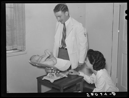 Weighing baby at medical center. Greenbelt, Maryland