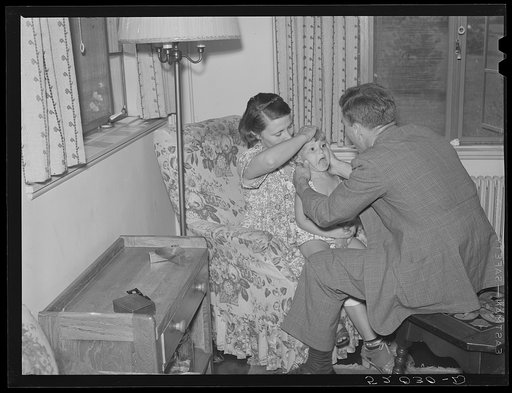 Doctor examining child in home. Greenbelt, Maryland