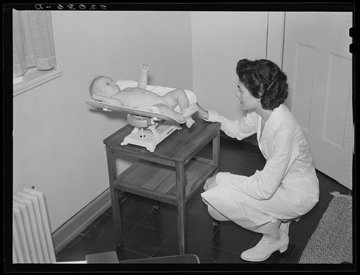 Weighing baby at medical center. Greenbelt, Maryland