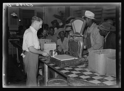 Untitled photo, possibly related to: Negro day laborers brought in truck from nearby towns, waiting to be paid off for cotton picking and buy supplies inside plantation store on Friday night. Marcella Plantation. Mississippi Delta. Mississippi