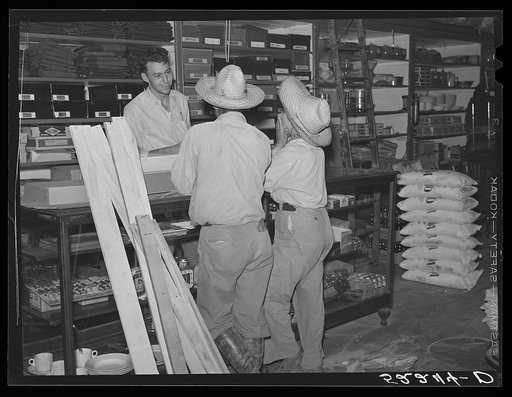 Mexican cotton pickers inside plantation store. Knowlton Plantation, Perthshire, Mississippi Delta. This transient labor is contracted for and brought in trucks from Texas each season