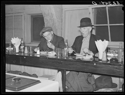 Farmers eating in cafe under tobacco warehouse during auction sale. Durham, North Carolina