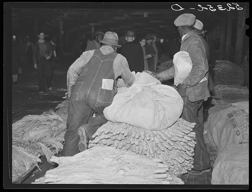 Farmers waiting around at tobacco auction. Durham, North Carolina