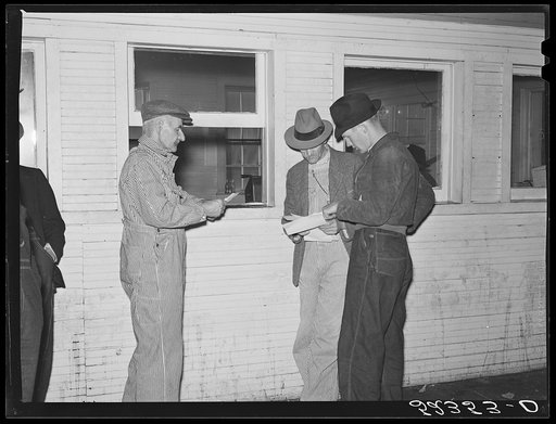 Farmers getting their checks after sale of tobacco at auction in warehose. Durham, North Carolina
