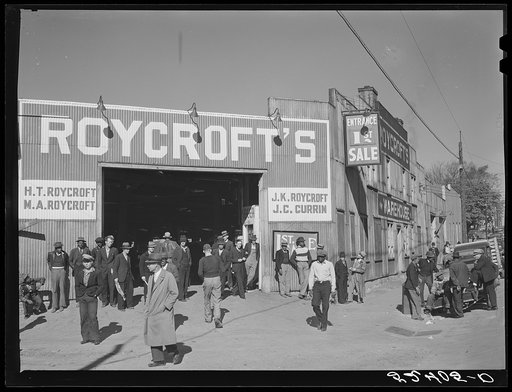 Untitled photo, possibly related to: Many stories are exchanged by buyers and farmers while waiting around outside warehouse during auction sales. Durham, North Carolina