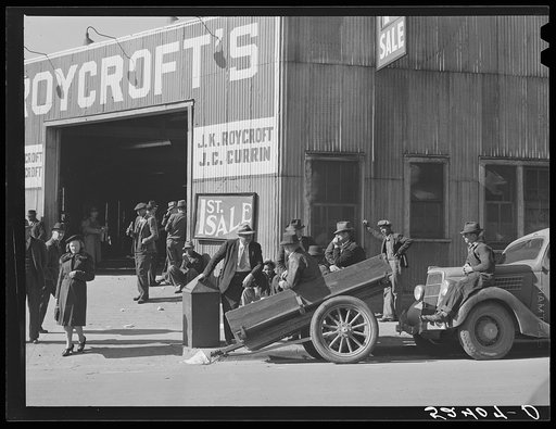 Many stories are exchanged by buyers and farmers while waiting around outside warehouse during auction sales. Durham, North Carolina