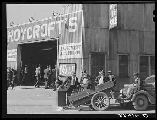 Untitled photo, possibly related to: Many stories are exchanged by buyers and farmers while waiting around outside warehouse during auction sales. Durham, North Carolina