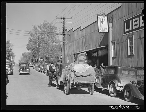 Tobacco coming in trailers to the warehouse for auction sale. Durham, North Carolina