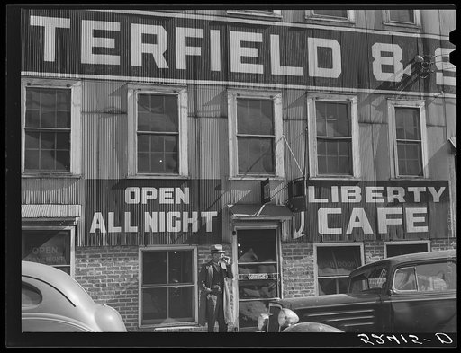Side of tobacco warehouse showing sign of all night caf.̌ Durham, North Carolina
