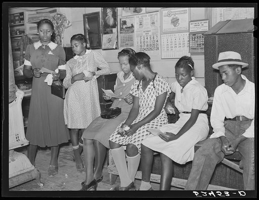 Negroes help each other read their mail in plantation store on Saturday morning. Mileston Plantation, Mississippi Delta