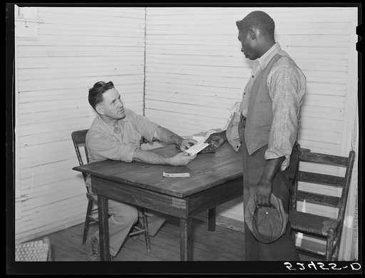 Untitled photo, possibly related to: Good Hope Plantation manager paying off on Saturday in plantation store. Mileston, Mississippi