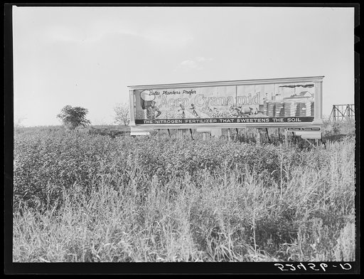 Billboard advertising fertilizer which is dusted over the cotton fields by aeroplanes. Mississippi Delta