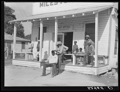 Untitled photo, possibly related to: Negroes cut each others' hair in front of plantation store after being paid off on Saturday. Mileston Plantation, Mississippi Delta