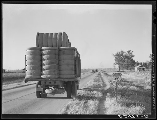 Truck with bales of cotton from Hopson Planting Company gin going up highway to warehouse near Clarksdale, Mississippi Delta