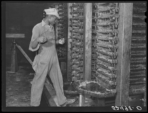 Cleaning the press in a cottonseed oil plant. Clarksdale, Mississippi Delta