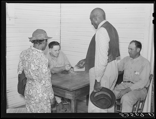 Good Hope Plantation. Manager paying off on Saturday in plantation store. Mileston Plantation, Mississippi Delta