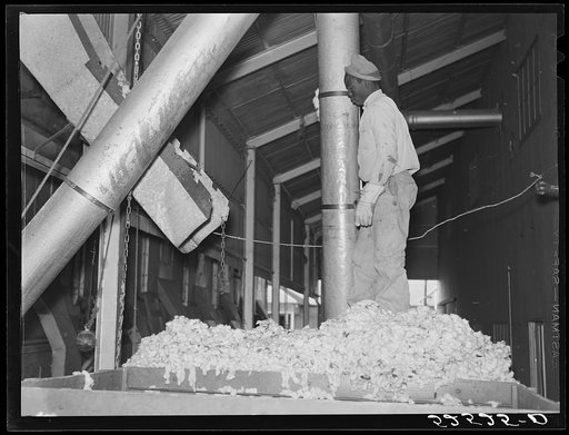 Untitled photo, possibly related to: Taking the cotton from the truck into the gin through large metal suction tube. Hopson Plantation, Clarksdale, Mississippi Delta