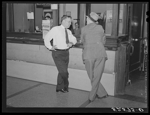 President of Memphis cotton exchange discussing business with one of the members on the floor