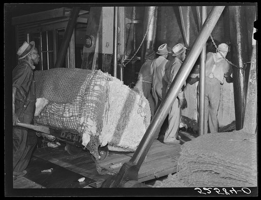 Untitled photo, possibly related to: Bale of cotton going into the compress. Memphis, Tennessee